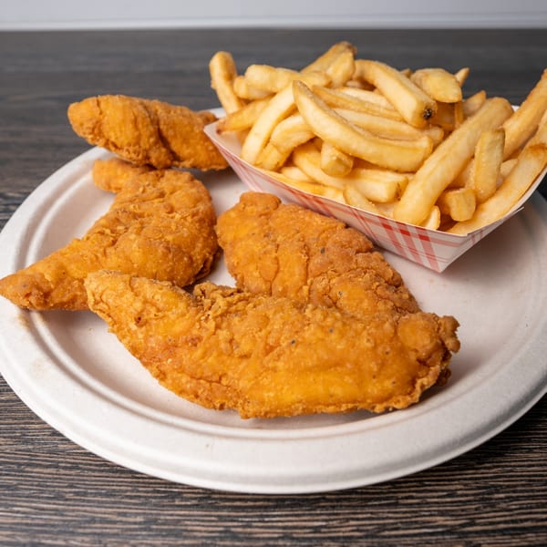 Rosie's Corner Take Out Restaurant's crispy chicken tenders and golden french fries on a white plate.