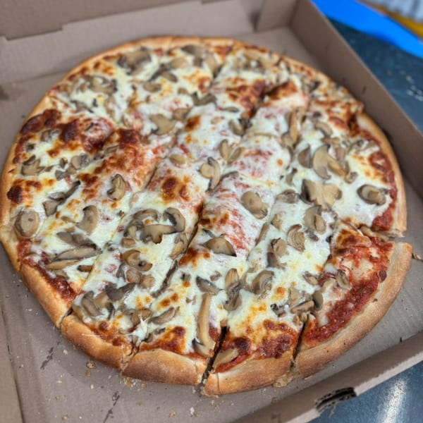 A whole mushroom pizza from Rosie's Corner Take Out, sliced and ready to eat in a cardboard box.