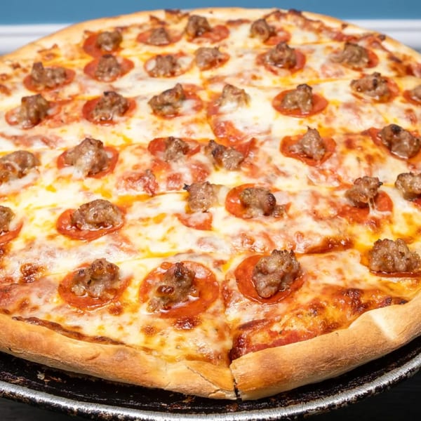 Rosie's Corner Take Out Restaurant's pepperoni and sausage pizza with melted cheese on a dark pan.